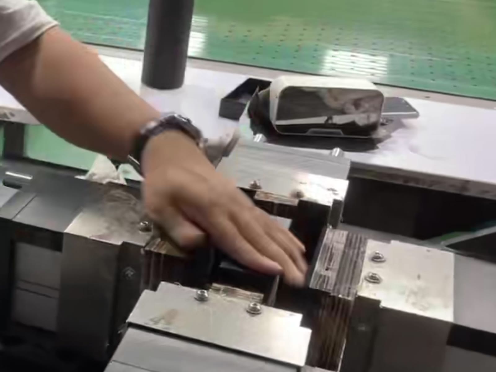 Close-up of a worker forming a paper box on a semi-automatic assembly machine